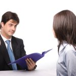 Job interview panel discussing work ethic with a candidate.